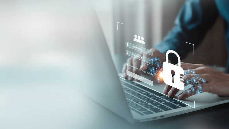 Person am Laptop mit digitalem Login-Schloss-Overlay — DSGVO-konforme Cloud-Dienste
